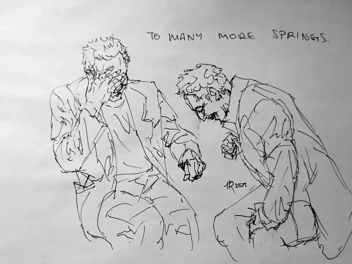 A pen sketch of actors Christopher Walken and John Turturro, two older men, cackling together around a table that has not been drawn. The lines are loose and sharp, trying to capture the motion of laughter. Walken is covering his face but leaving a wide grin visible underneath his palm, while Turturro bends down in a defeated wheeze, crow’s feet gathering on the corners of his eyes.