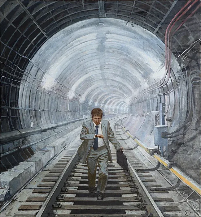 A man in a formal suit runs through a railway tunnel, on the tracks, just having passed from a well lit area into a dark one. He carries a briefcase and is checking his wristwatch nervously.